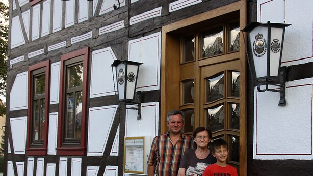 A traditional half-timbered building with a sign indicating it is a pub. - Landhotel zur Krone (Krayenberggemeinde)