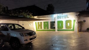 A parking garage entrance with a white SUV parked inside. - Hotel Haedo (Haedo)