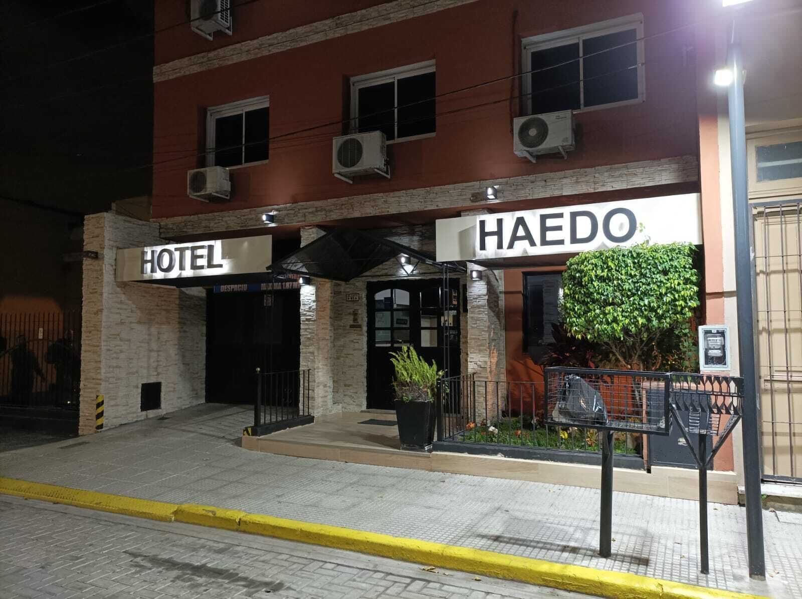 A hotel entrance with a sign reading "HAEDO HOTEL" and an air conditioning unit on the wall.