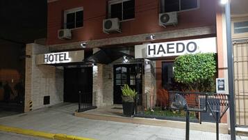 A hotel entrance with a sign reading "HAEDO HOTEL" and an air conditioning unit on the wall.