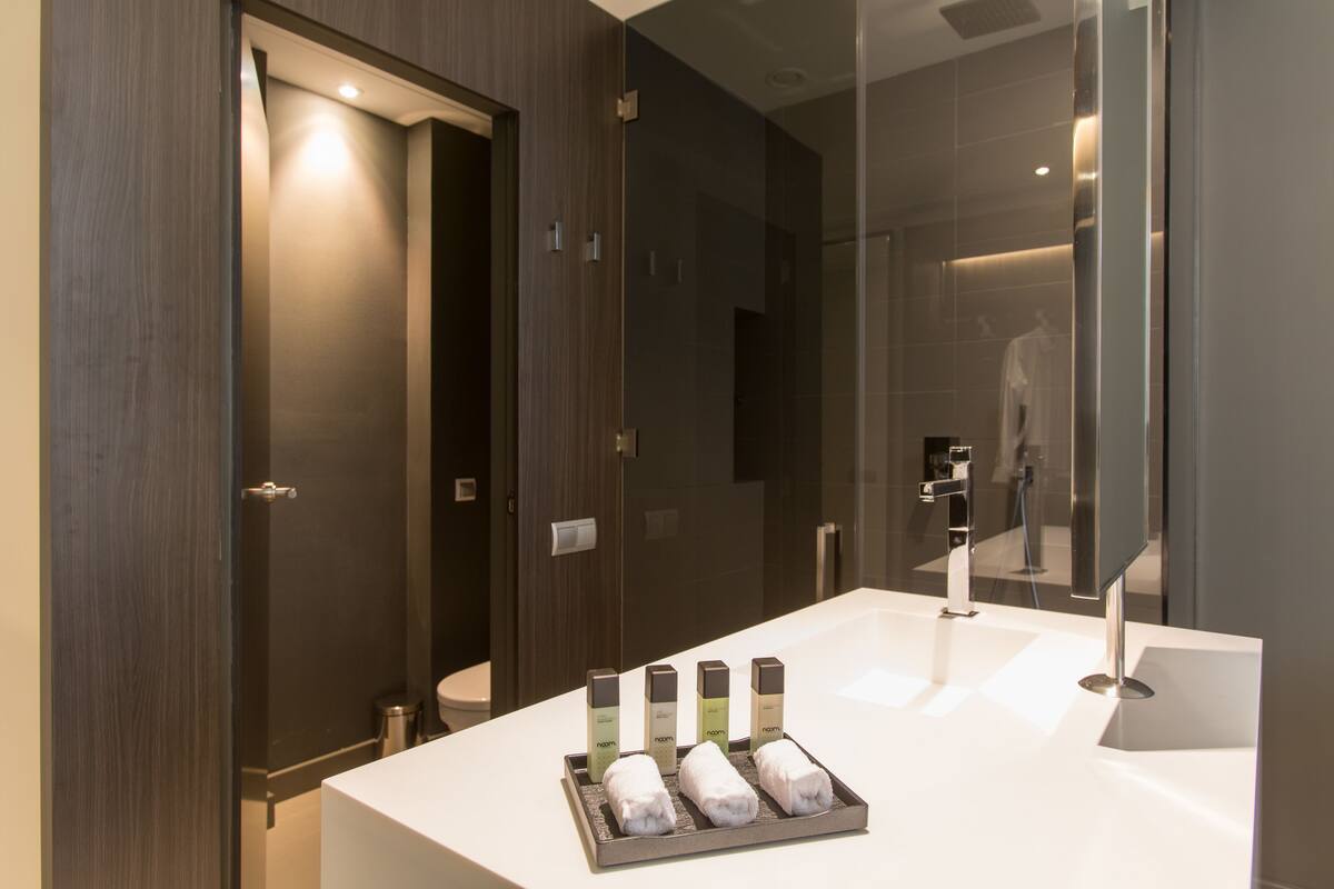 deep-soaking bathtub, rainfall showerhead, free toiletries, bathrobes