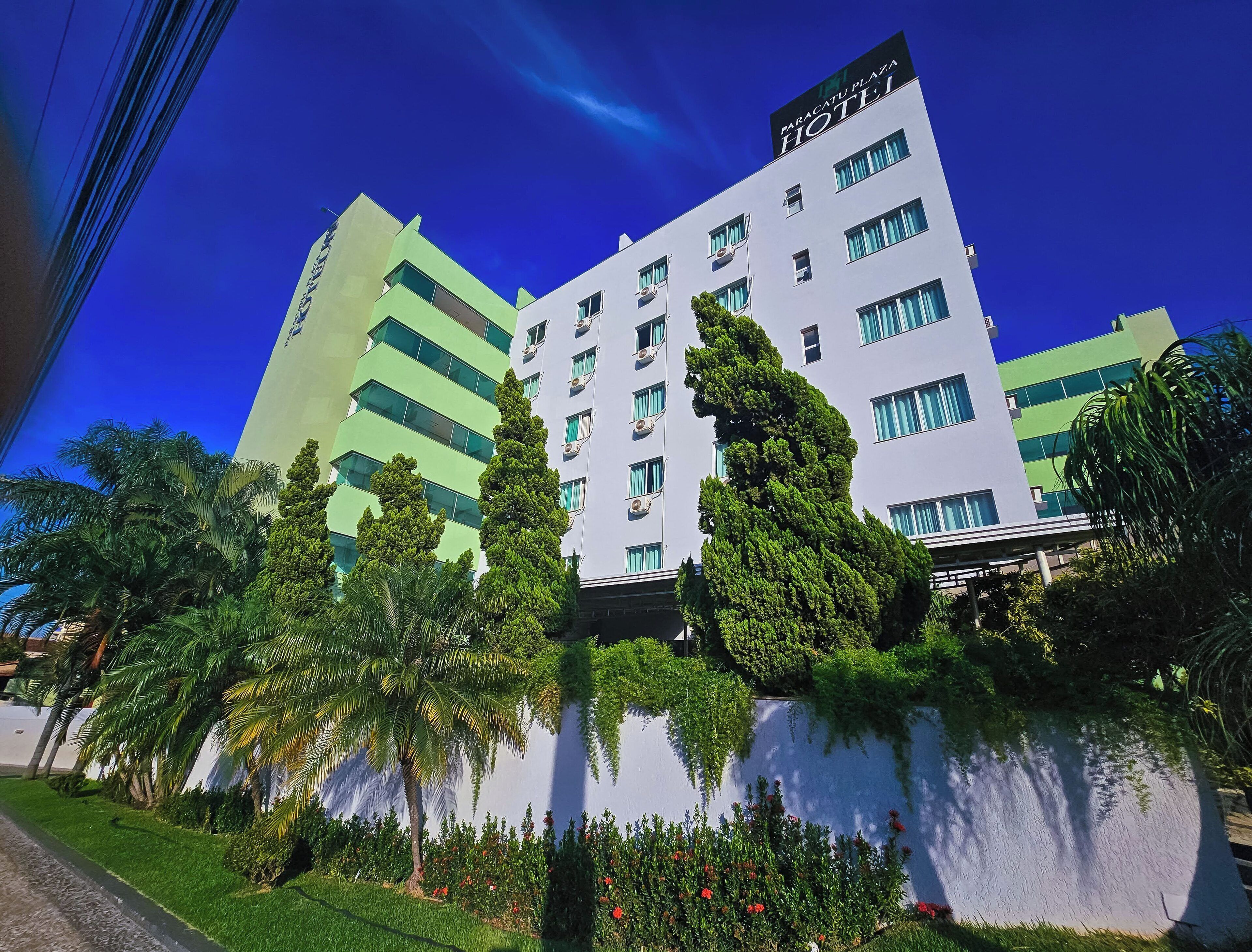 A hotel with a modern design, featuring multiple floors and a prominent sign.
