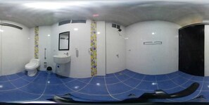 A bathroom with a toilet, sink, and shower. - Cabañas Juakianna (Tolú)