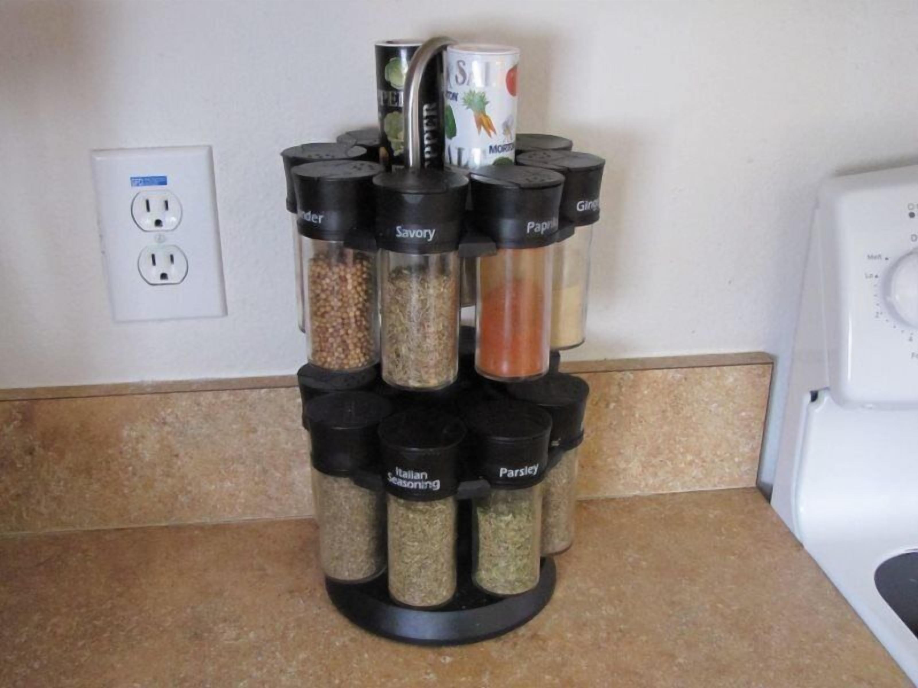 A spice rack with labeled containers for Italian seasoning, Savory, Ginger, Paprika, and Parsley.