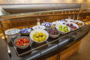 A buffet with various fruits and dairy products.