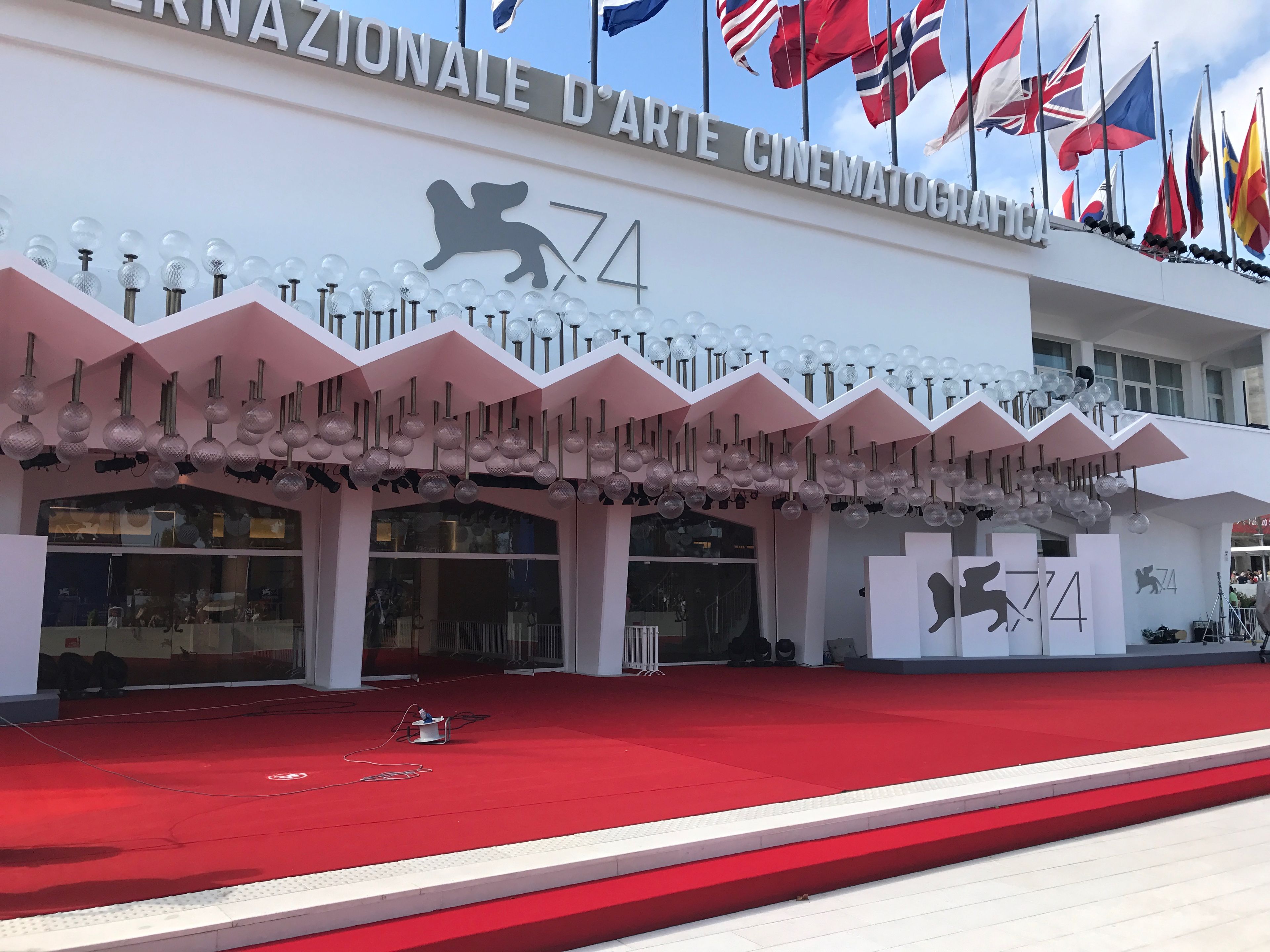 The entrance of the National Art Cinema with a red carpet and a lion logo.