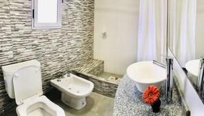 Un bagno con il water, bidet e lavandino.
