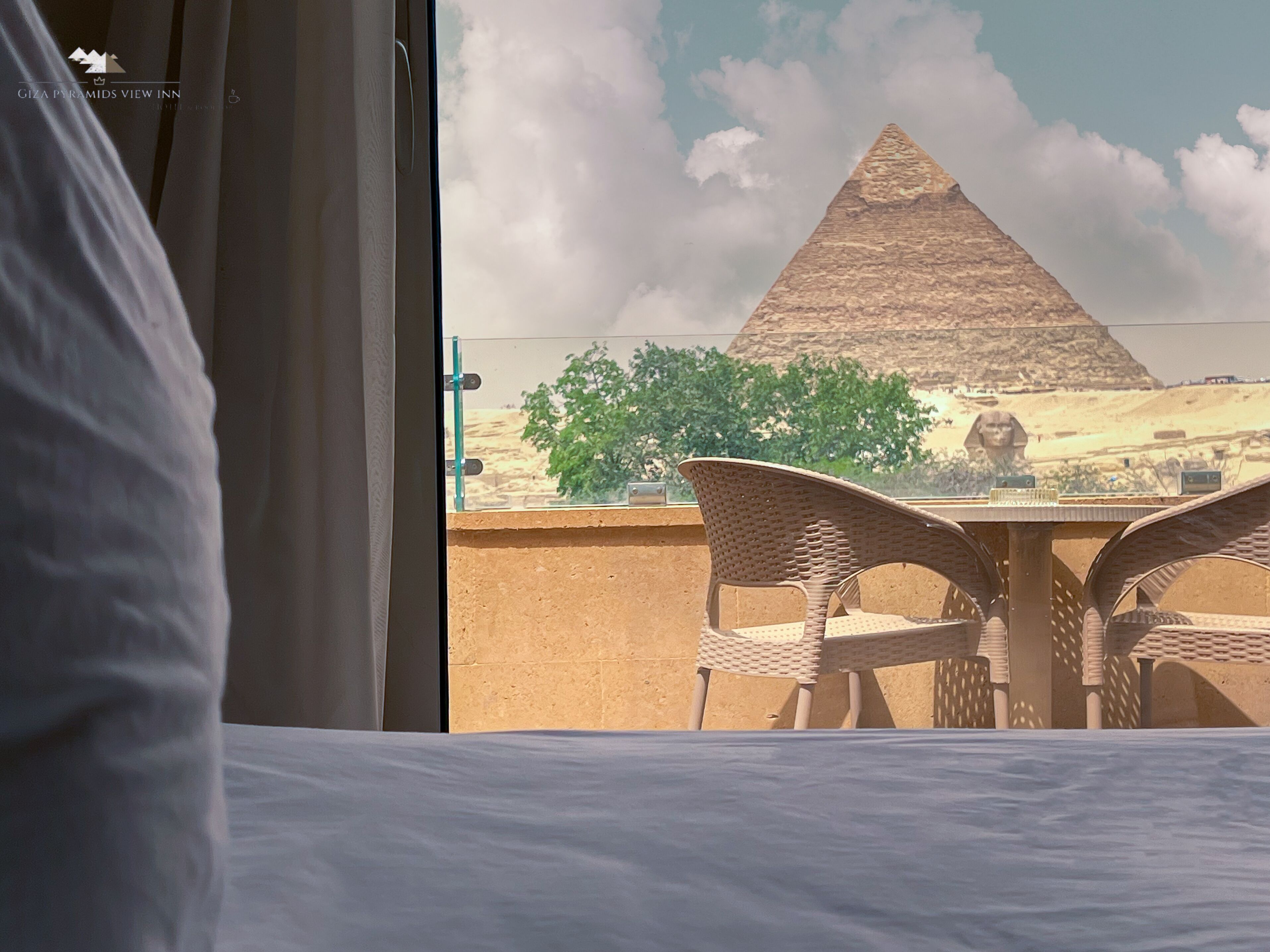 A hotel room with a view of the Giza Pyramids.