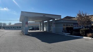 A gas station with a clear sky and a visible rainbow. - Ambassador Inn And Suites (Manchester)