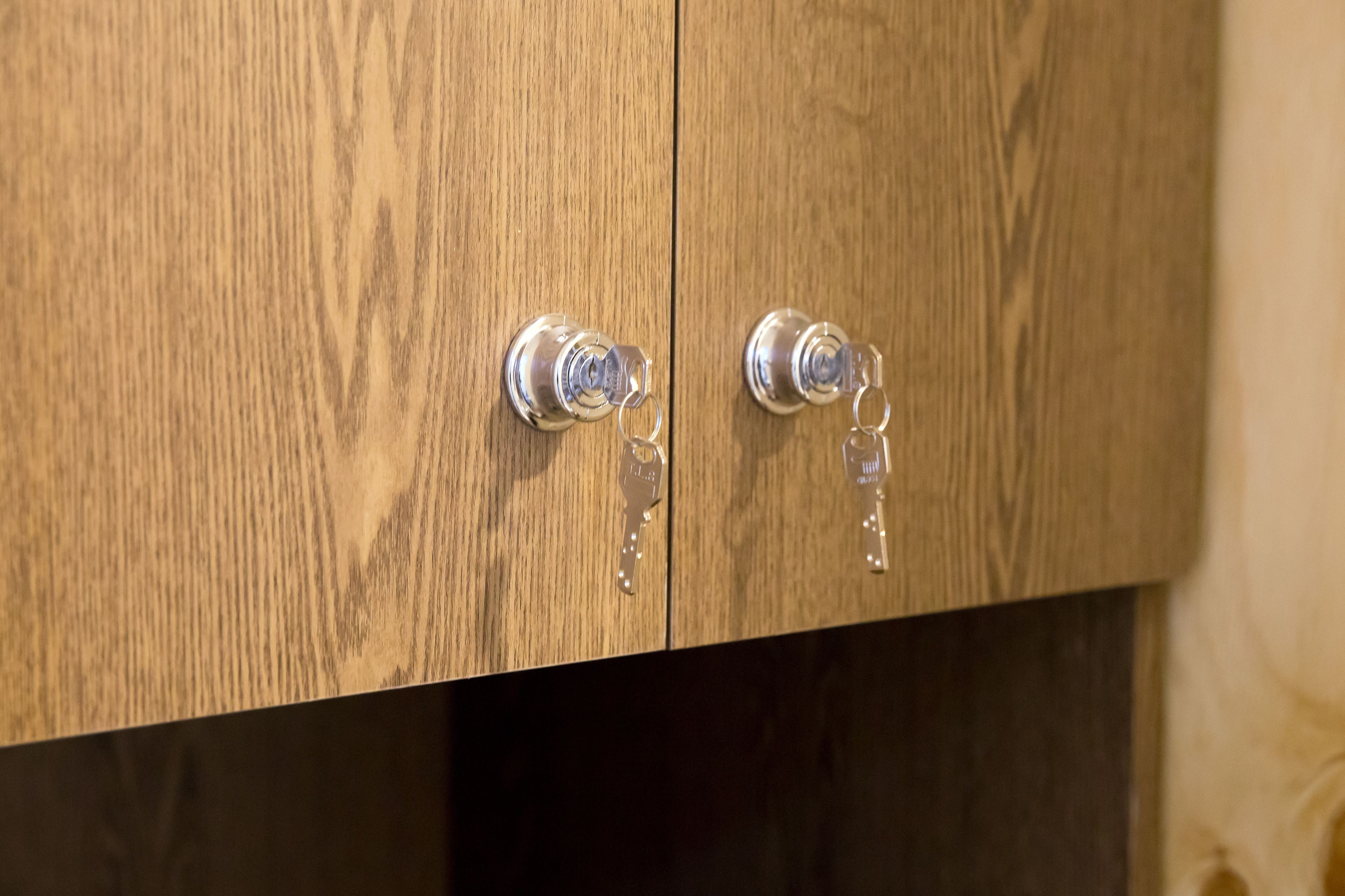 A wooden cabinet with two metallic handles.