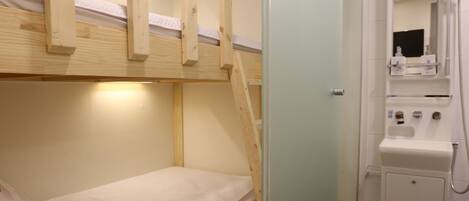 A bunk bed with a wooden frame and a glass shower enclosure.