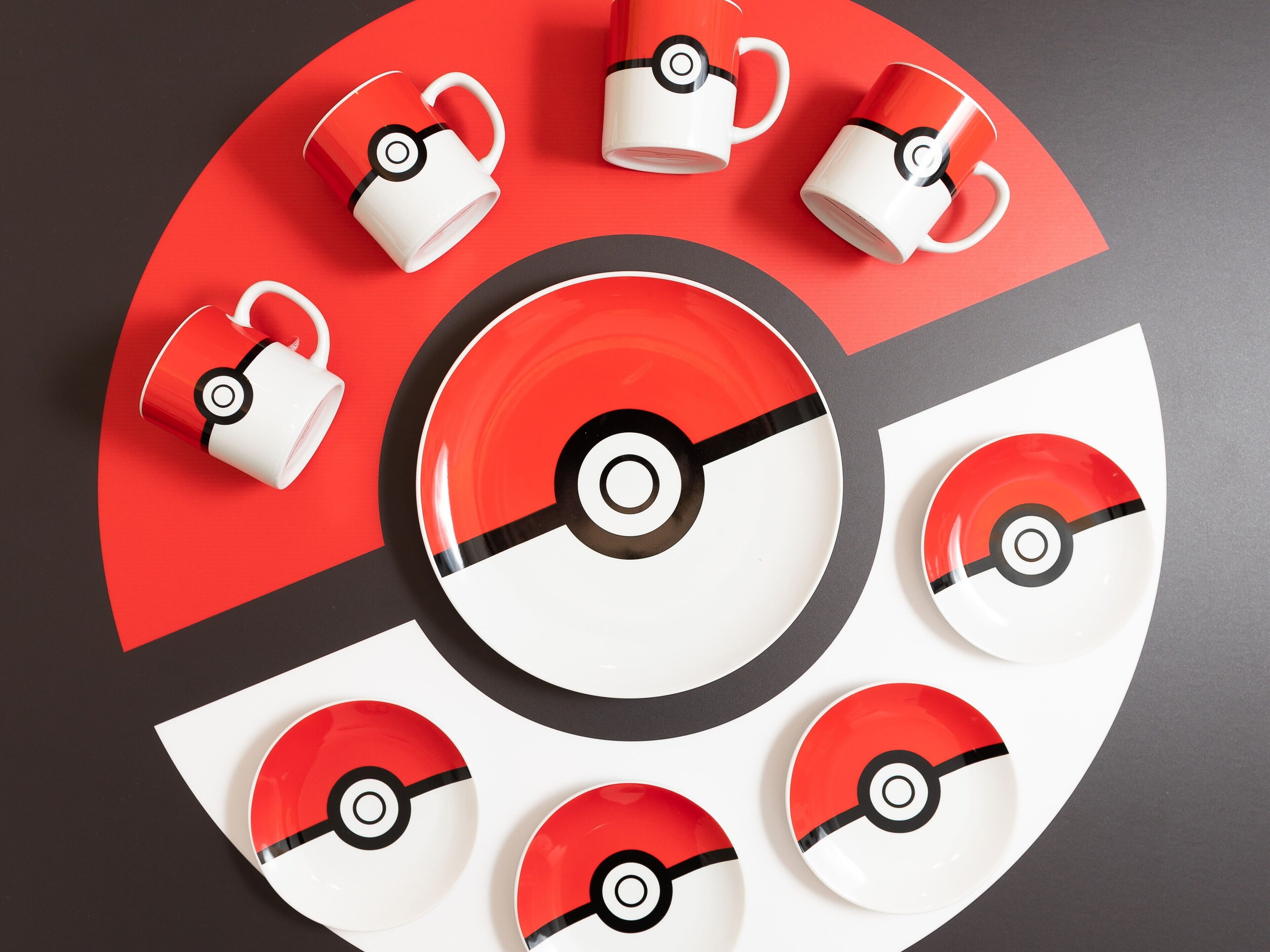 A circular arrangement of tableware with a Poké Ball design.