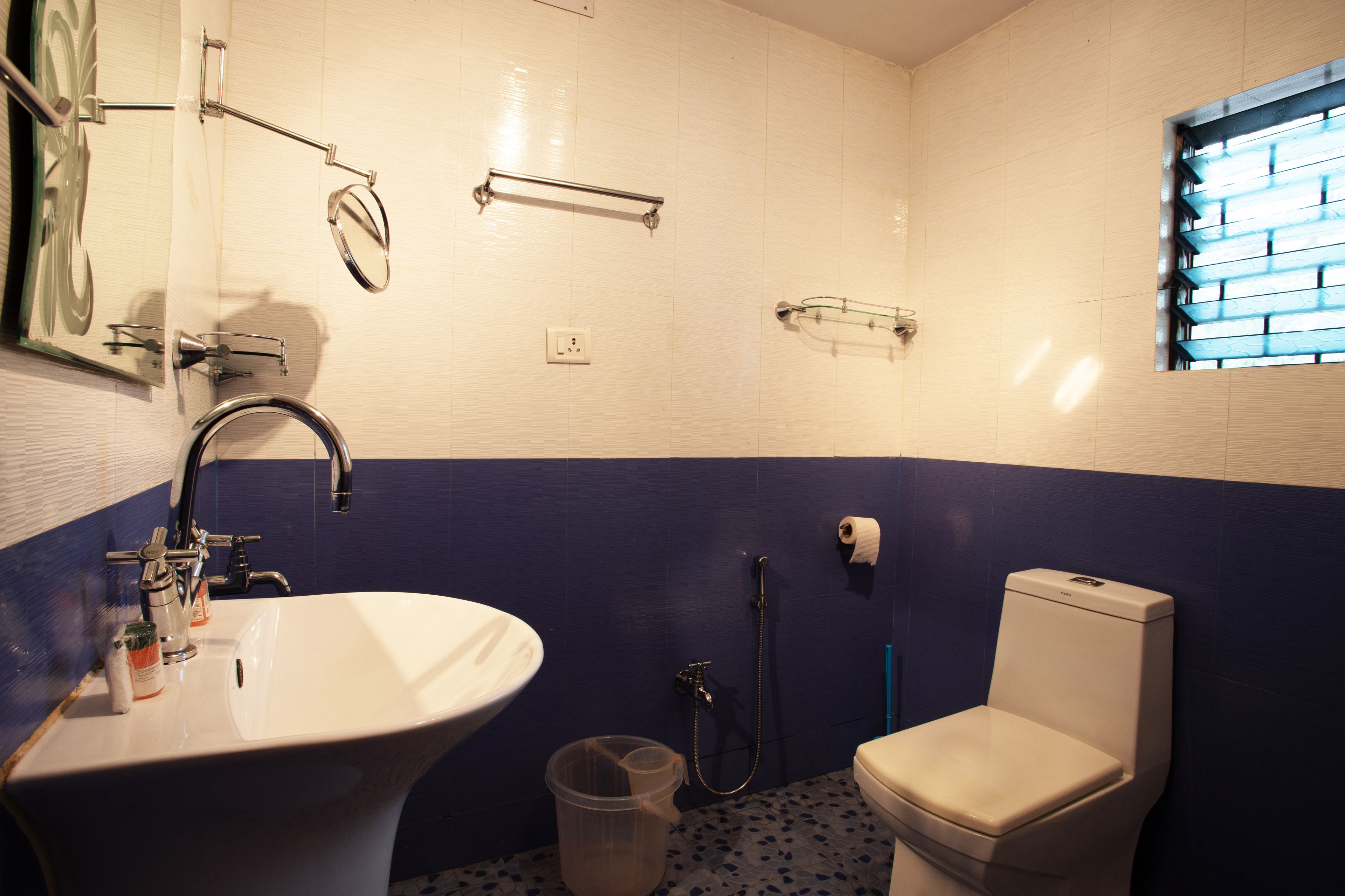 A bathroom with a white sink, a toilet, and a shower.