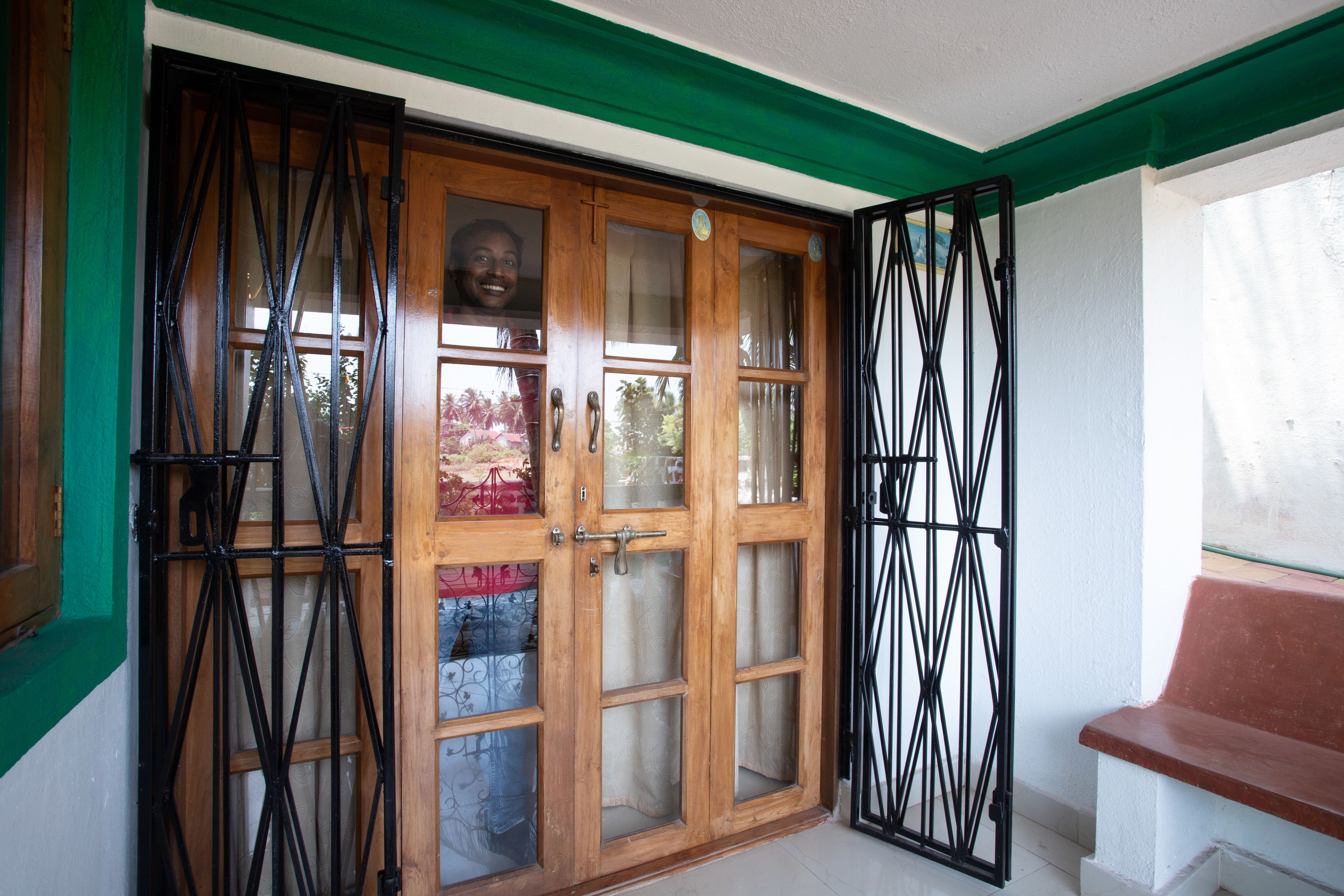 A wooden door with glass panels and a metal gate.