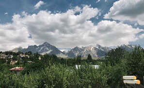 A mountainous landscape with a village in the foreground and snow-capped peaks in the background. - Taurus Guest House (Çamardi)