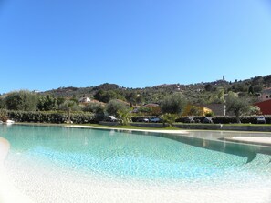 Seasonal outdoor pool, pool umbrellas, pool loungers