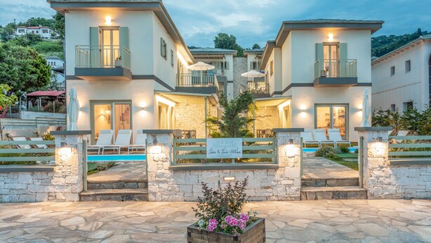 A modern villa with a pool, outdoor seating, and a sign indicating 'Sea & Sun Villas'. - Sea and Sun Luxury Pools' Villas (Zagora-Mouresi)