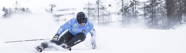 A person skiing on a snowy slope.
