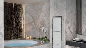 A modern bathroom with a marble floor, a freestanding bathtub, a large mirror, and a wall-mounted towel rack.