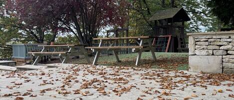 Un parque con una mesa de picnic y muros de piedra.