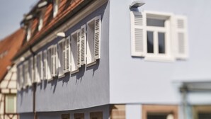 A building with multiple windows and shutters, featuring a traditional architectural style with a prominent gable roof. - Bachofer (Waiblingen)