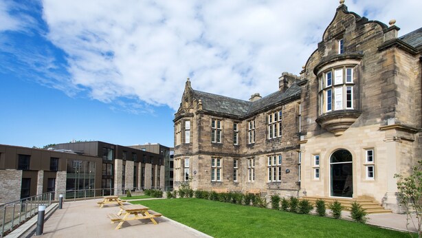 A historic building with a courtyard, large windows, and a stone facade. - Popup Durham (Durham)