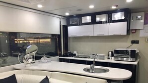 A modern kitchen with a white countertop, a built-in sink, and black cabinets.