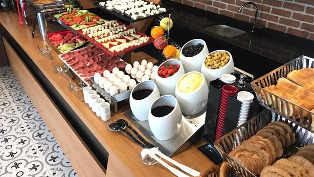 A buffet with various food items including fruits, cheeses, and bread. - White Golden Suite Hotel (Trabzon)
