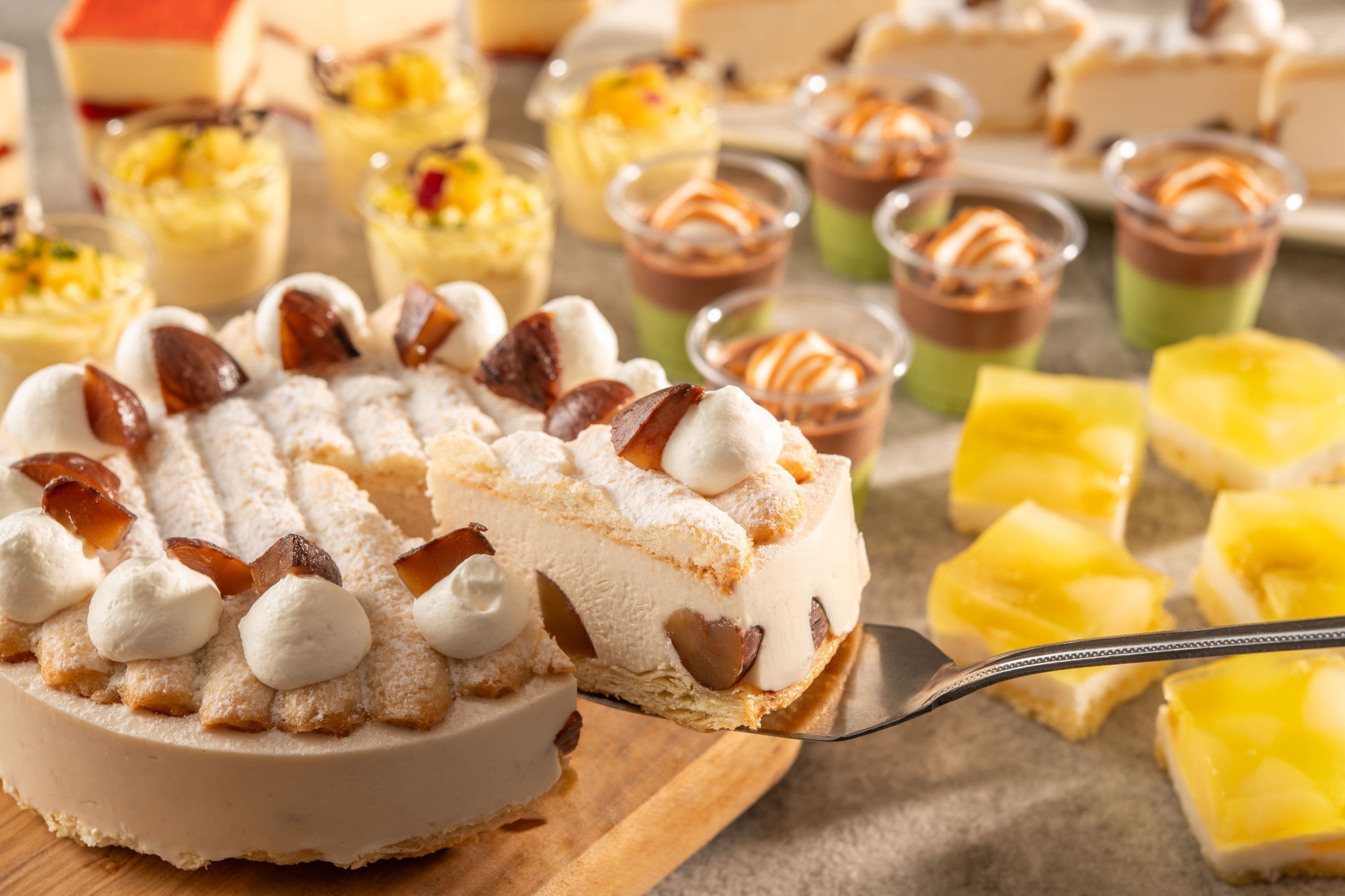 A variety of desserts including a slice of cake with meringue and caramel.