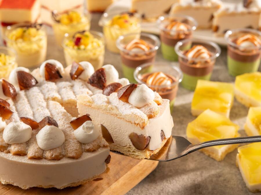 A variety of desserts including a slice of cake with meringue and caramel.