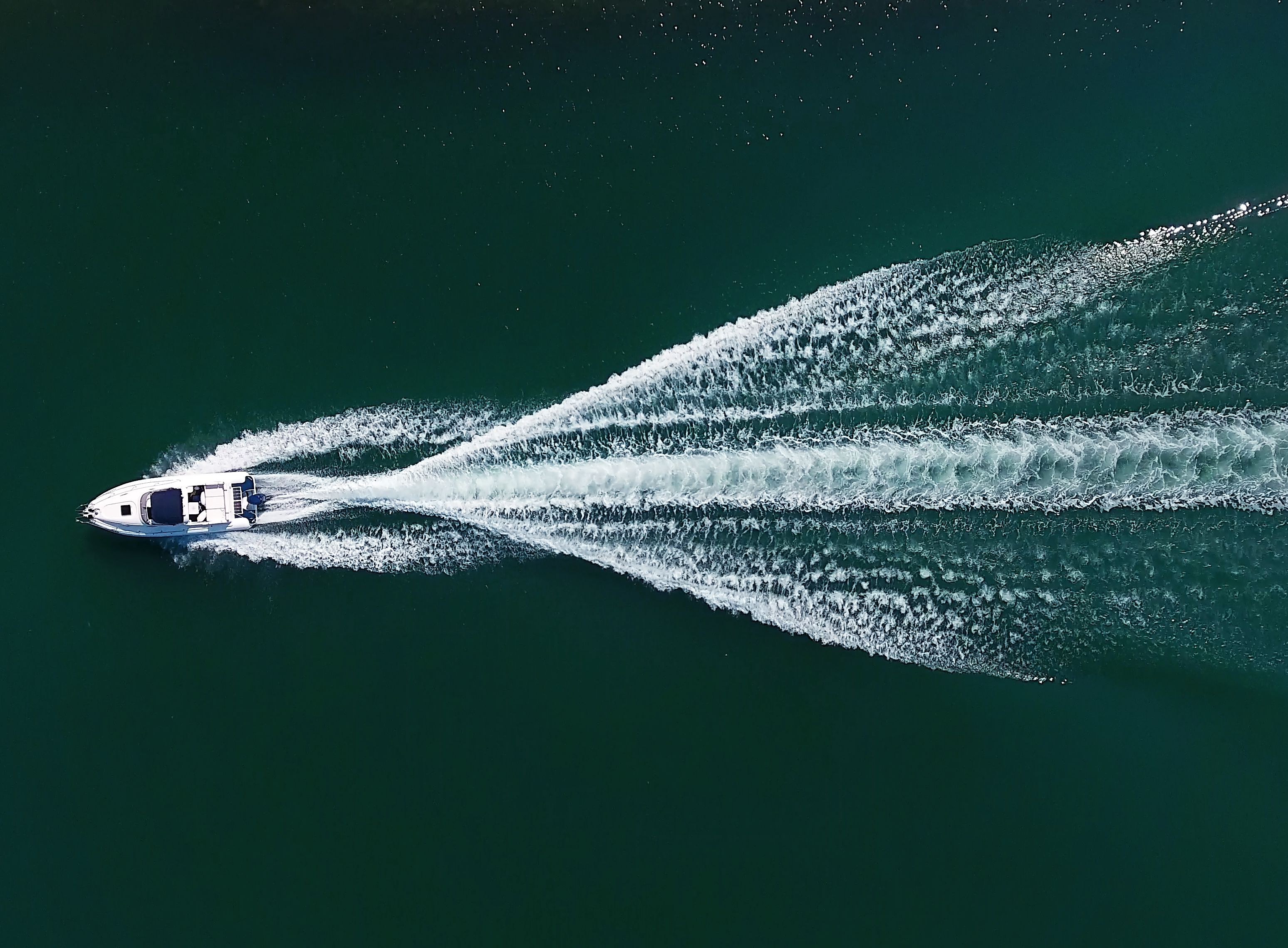 A boat creating a wake in the water.