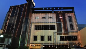 A hotel facade with vertical string lights, a prominent 'HOTEL REDPETAL' sign, and a modern architectural design. - Treebo Red Petal Jalandhar (Jalandhar)