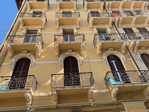A multi-story building with ornate balconies and arched windows. - Promenade Maison de Charme (Sanremo)