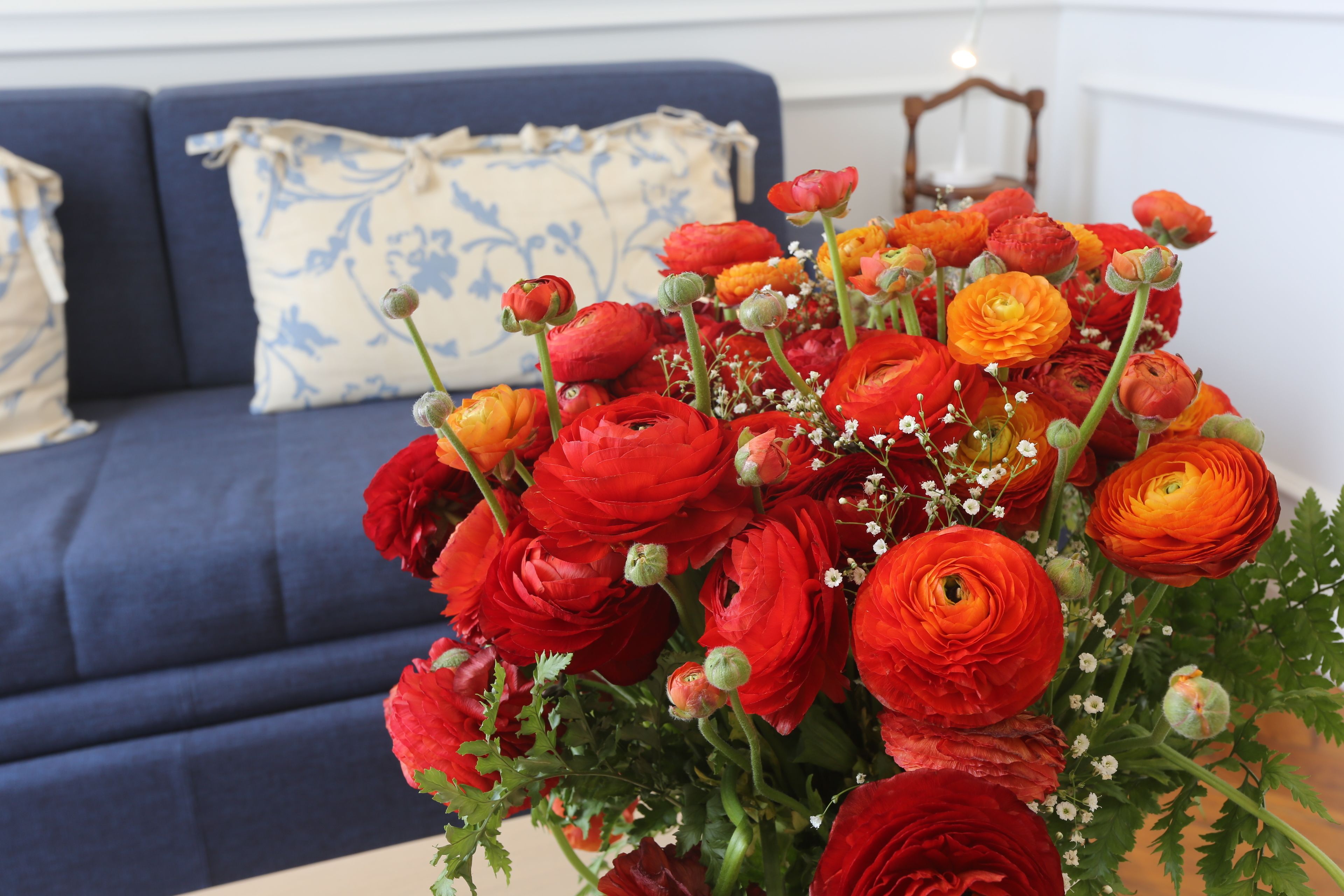 A bouquet of red and orange flowers in a vase.