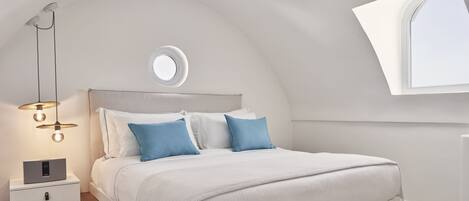 Een moderne slaapkamer met een bed, nachtkastje en een raam met uitzicht.