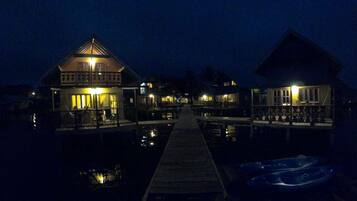 A waterfront property with multiple overwater bungalows connected by a dock.