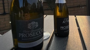 A bottle of Prosecco and a bottle of A&O Prosecco on a table with a sunset view. - The Moorings (Chester-le-Street)
