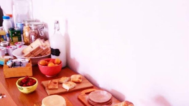 A breakfast buffet with various food items and a glass display of croissants. - B&B La Bussola (Pachino)