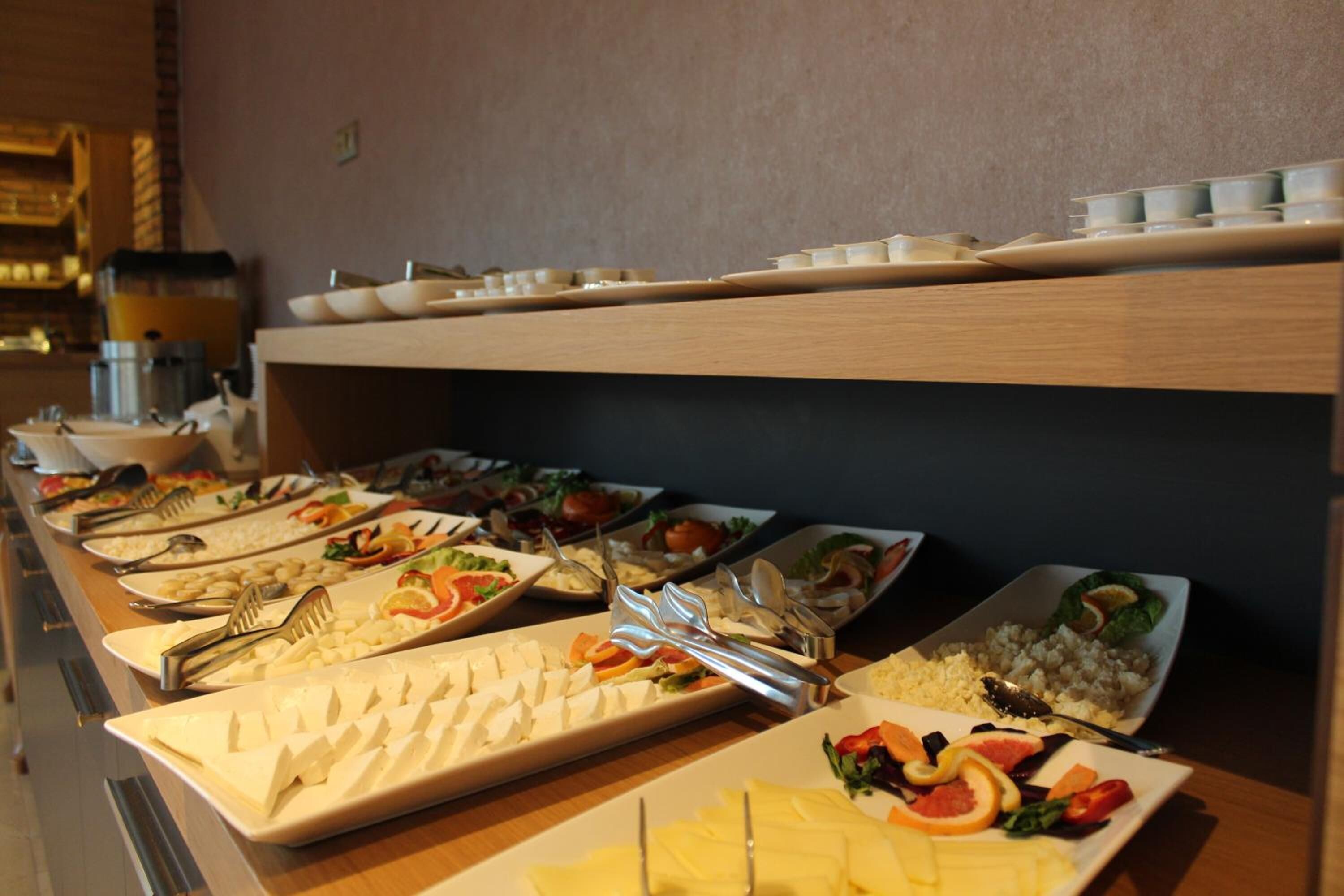 A buffet with various food items and utensils.