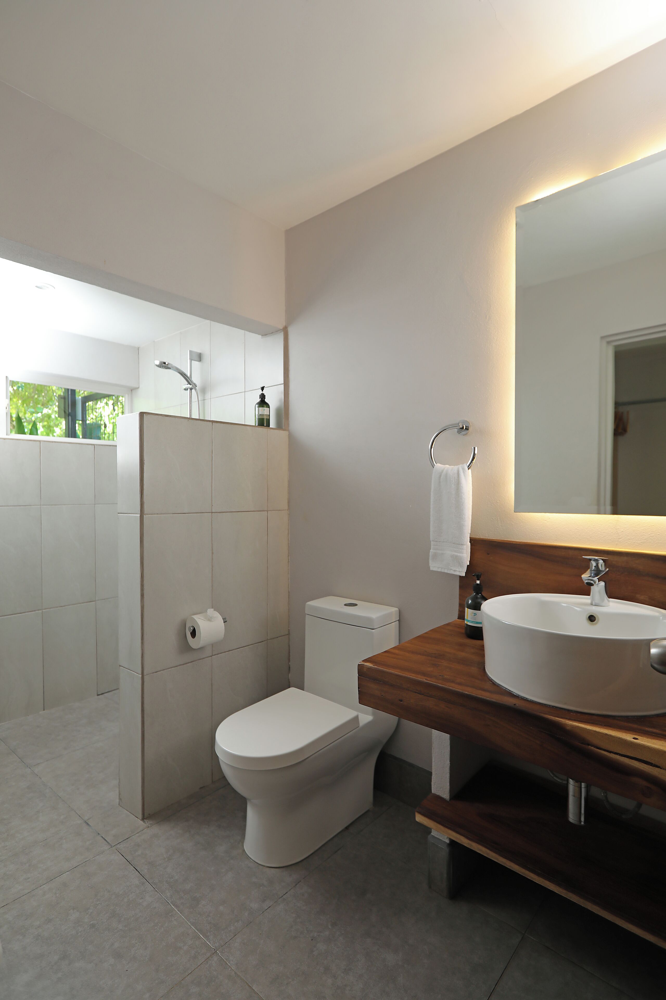 A modern bathroom with a toilet, bidet, and sink.