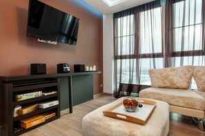 Departamento, 1 habitación | Área de sala de estar | Televisión de pantalla plana 