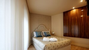Un dormitorio moderno con una cama grande, un armario de madera y una pared estampada.