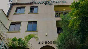 A hotel named "Capernaum Hotels" with a sign above the entrance. - Capernaum Hotels (Kampala)