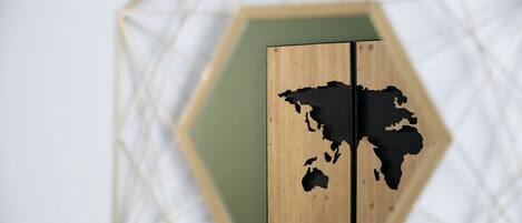 A wooden world map on a hexagonal wall.