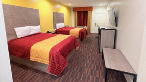 A hotel room with two beds, a desk, a television, and a door. - Americas Best Value Inn & Suites Houston Veterans Memorial (Houston)