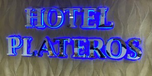 A sign with the words "HOTEL PLATEROS" in illuminated letters. - Hotel Plateros (Cusco)