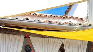 A covered outdoor seating area with a hammock, wooden chairs, and a table. - Rural house (Las Mimbres house 1) 10 people Rivera n 4 (Fuentes de Béjar)
