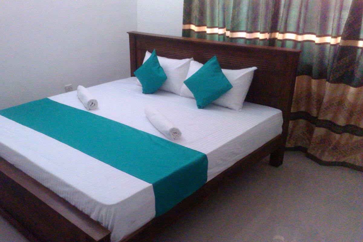 Desk, iron/ironing board, bed sheets