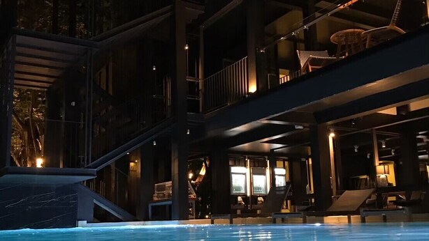A modern indoor pool area with a visible sign reading "POR". - POR Santitham (Chiang Mai)
