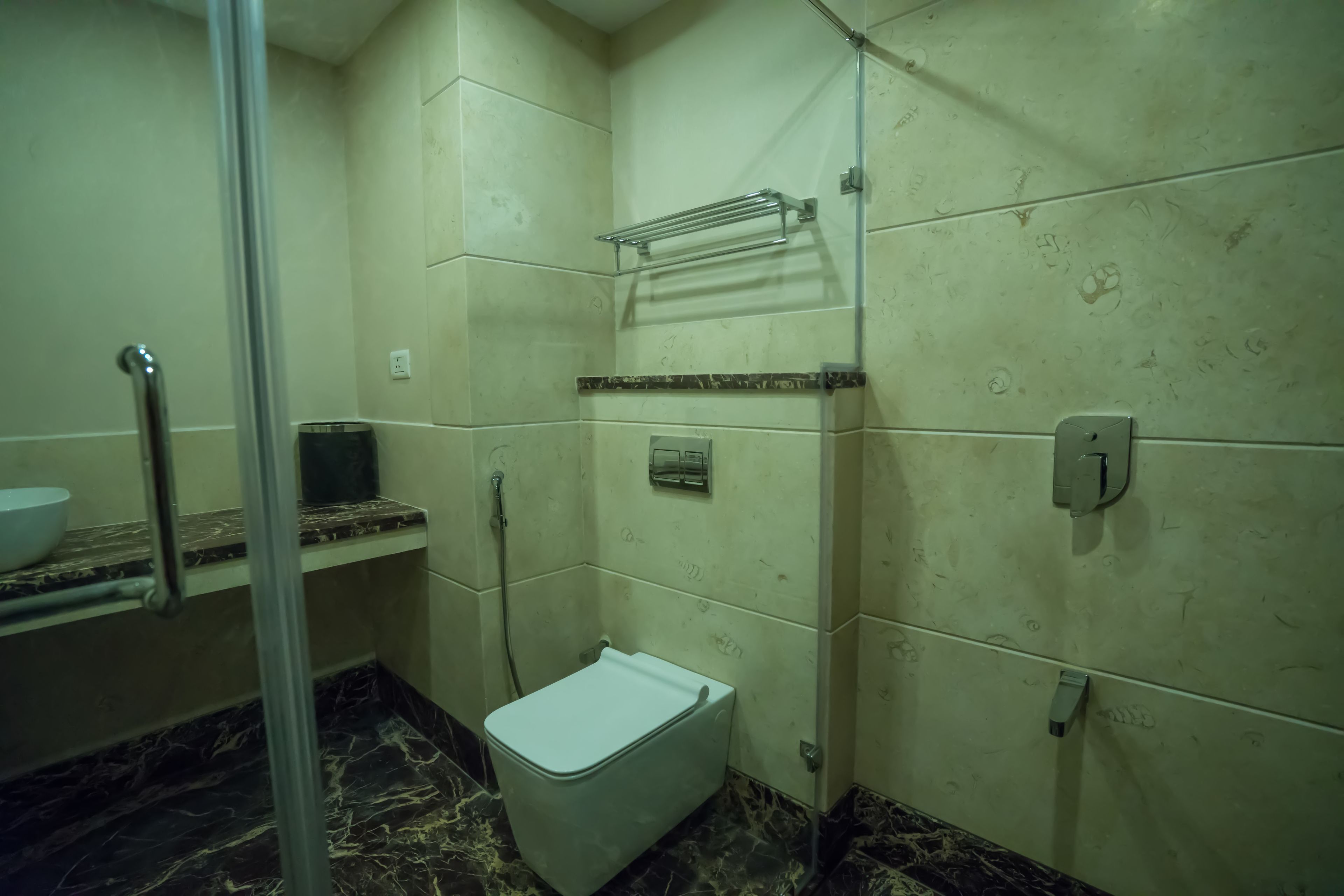 A small bathroom with a toilet, a sink, and a shower area.